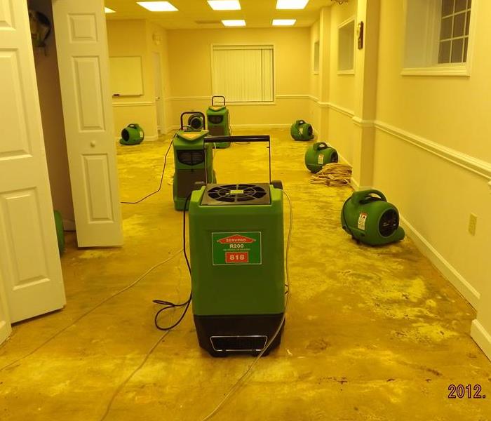 office with concrete floor and SERVPRO equipment set up