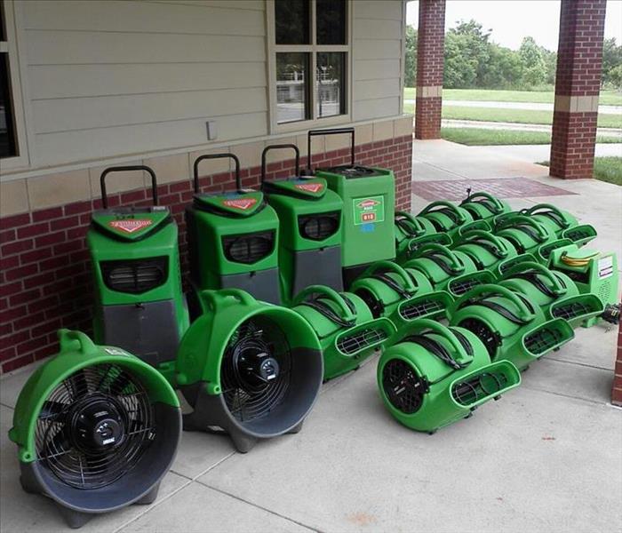 SERVPRO fans and dehumidifiers setup outside of a home