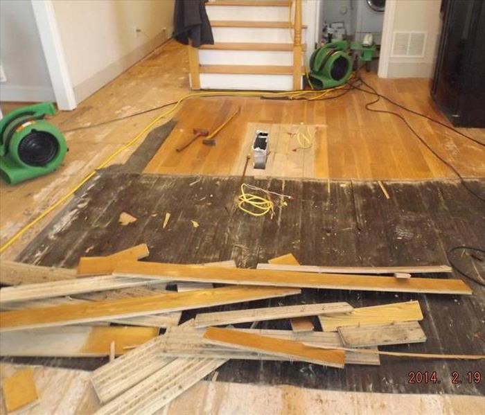 Hardwood floor slats torn from floor